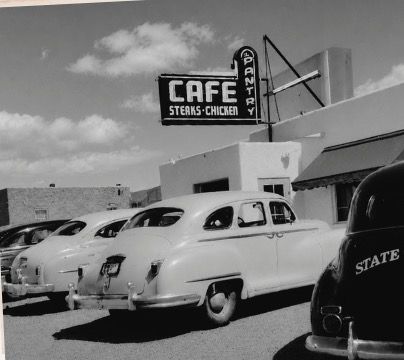The Pantry around 1949: a CAFE, STEAKS AND CHICKEN sign with PANTRY running down its side, above a row of late-1940s cars, one of them a state patrol car.